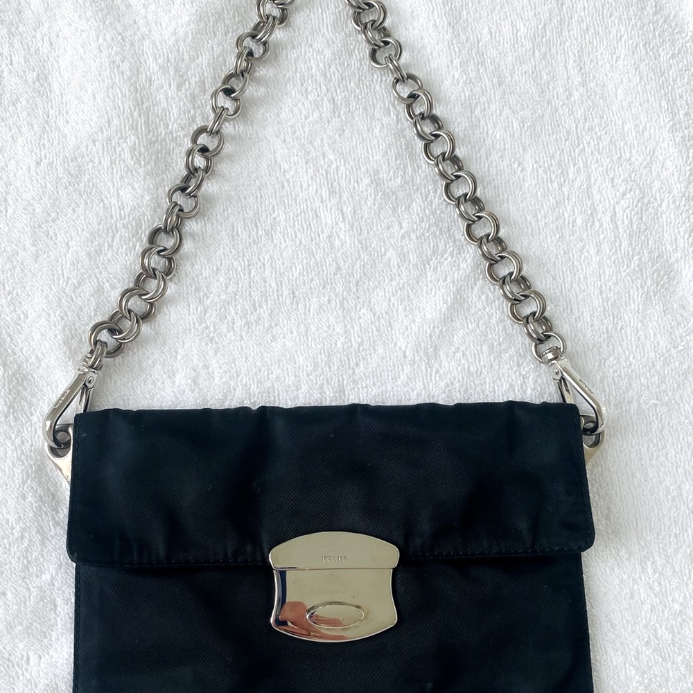 Prada authentic black nylon handbag with silver buckle and silver handle.